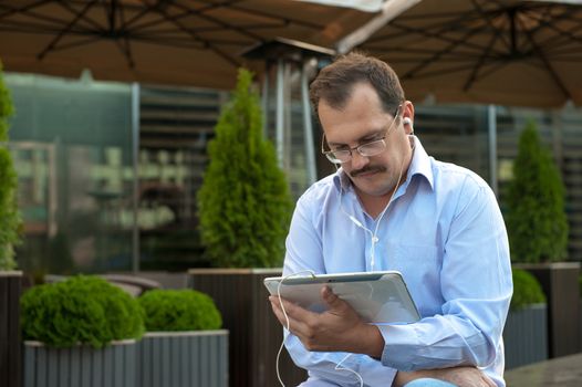 Man using tablet computer with high spees internet outdoors