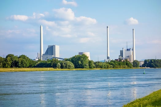 Karlsruhe, Germany - May 31, 2014: Steam power plant and hard coal-fired power station Rheinhafen-Dampfkraftwerk Karlsruhe EnBW, river Rhine in foreground.