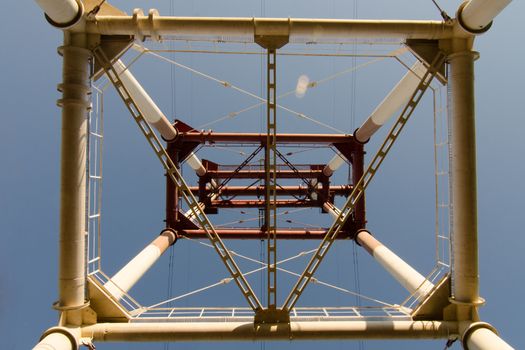 supports of high-voltage power lines against the blue sky