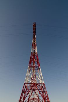 supports of high-voltage power lines against the blue sky