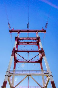 supports of high-voltage power lines against the blue sky