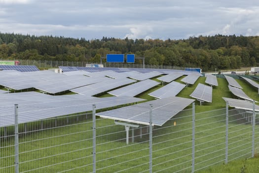 Field with blue siliciom solar cells alternative energy to collect sun energy