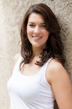 Portrait beautiful woman with dark hair smiling in the camera on grey background