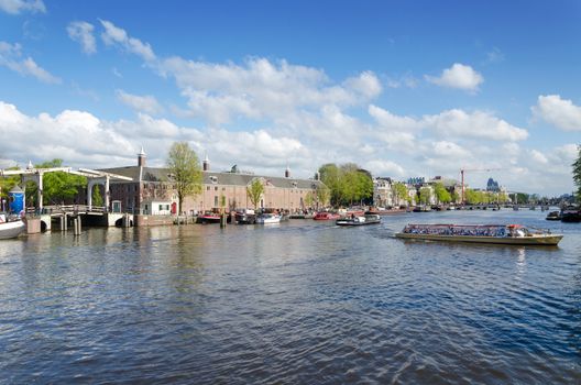 Tourist Boats on Amstel River in Amsterdam, The Netherlands