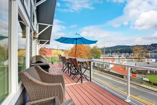 Northwest trditional wooden deck with water veiw and chairs.