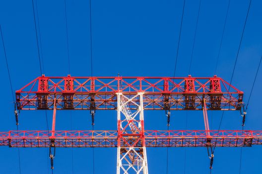 supports of high-voltage power lines against the blue sky