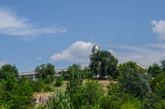 observatory on the background of blue sky with trees