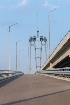 the construction of a bridge across the river with the supports, structural elements, cranes