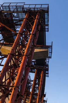 the construction of a bridge across the river with the supports, structural elements, cranes