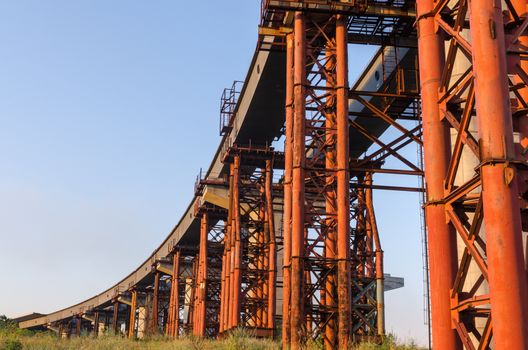 the construction of a bridge across the river with the supports, structural elements, cranes