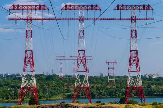 supports of high-voltage power lines against the blue sky