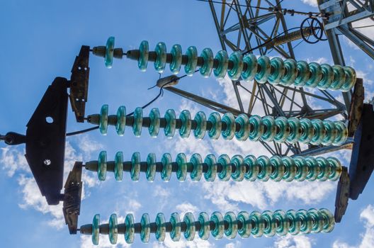 supports of high-voltage power lines against the blue sky