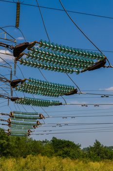 supports of high-voltage power lines against the blue sky