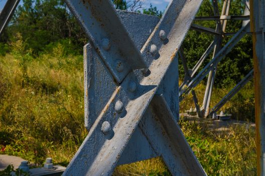 supports of high-voltage power lines against the blue sky