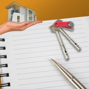 Humans hand holding house with keys and notebook