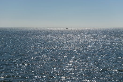 Sun over the Wadden Sea with fishing boat
