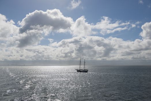 Sun over the Wadden Sea with sailing boat
