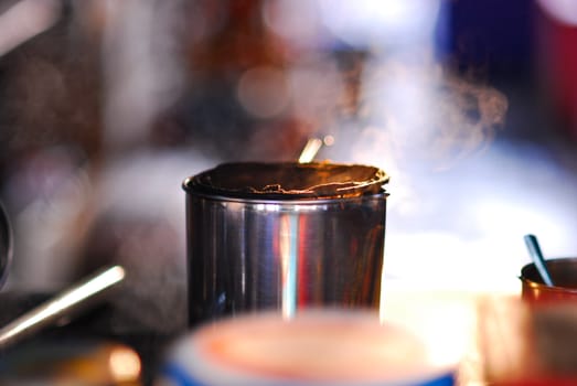 woman monger prepare hot herb tea in container stainless cup moring market