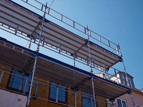 Modern sophisticated scaffolds on a house building under extensive renovations