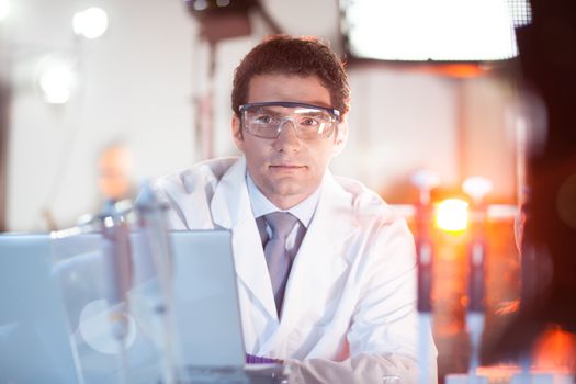 Portrait of a confident male engineer in his working environment. Science and technology concept.