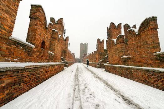 Ancient Scaligero bridge in winter when it is snowing - Verona (UNESCO world heritage site) - Veneto, Italy