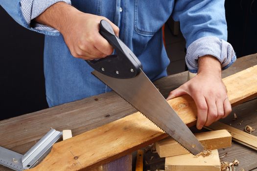 carpenter's hands - working with saw , close up