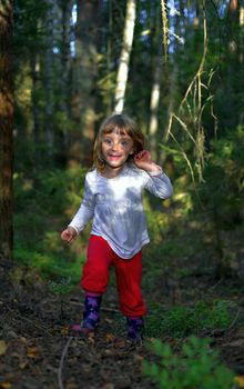 Smiling Happy little girl running on the summer forest  