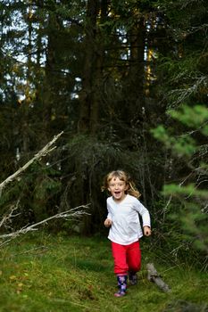 Smiling Happy little girl running on the summer forest  