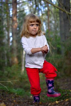 Little girl  in the summer forest 