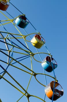 Ferris wheel on the background of blue sky