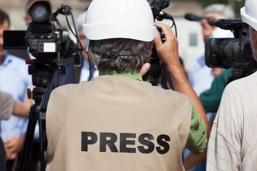 Filming an event with a video camera. Press conference.