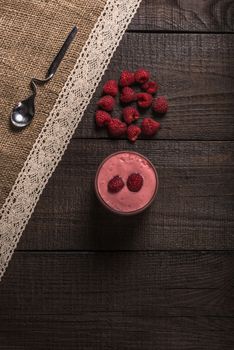 raspberry - banana smoothie on korichnevom the background of natural wood, lace