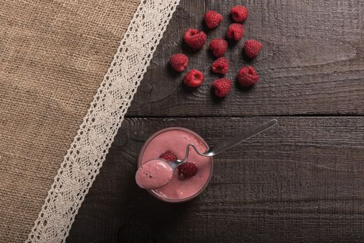 raspberry - banana smoothie on korichnevom the background of natural wood, lace