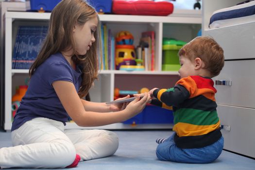 girl and her little brother arguing with a digital tablet computer