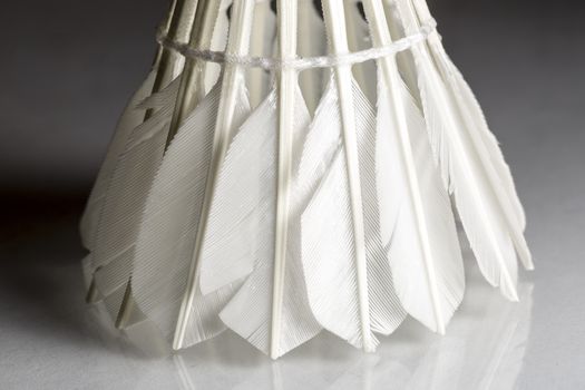 Feathered White Shuttlecock with grey background. Macro image.