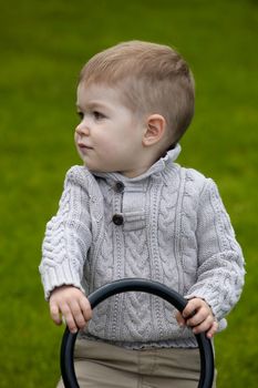 2 years old Baby boy on playground in spring outdoor park 