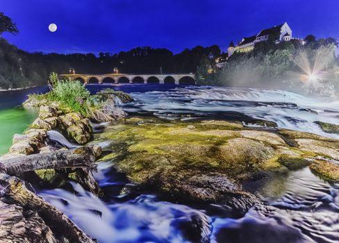 Rhinefalls by night with full moon, Switzerland