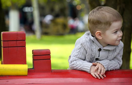 2 years old Baby boy on playground in spring outdoor park 