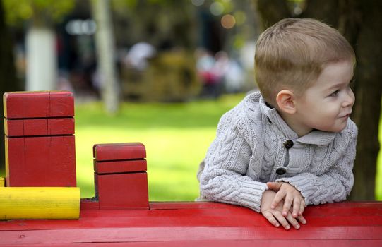 2 years old Baby boy on playground in spring outdoor park 