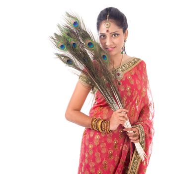 Portrait of beautiful Indian woman holding peacock feathers, isolated on white background.