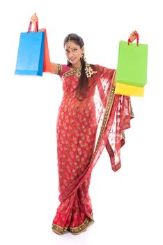 Indian woman in traditional sari shopping for diwali festival, full length standing isolated on white background.