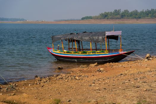 Indian colorful country boat tied at a river bank in Mukutmanipur.