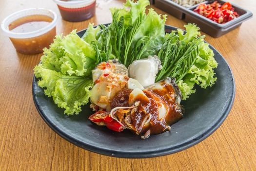 Thai local food, oyster with spicy sauce, eat with lettuce and acacia