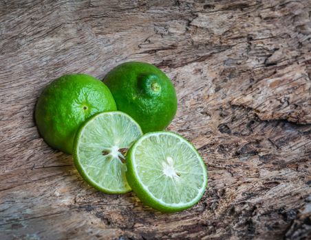 green lime on wooden background, insect repellent--ants and cockroaches. place on the corners to repel insects