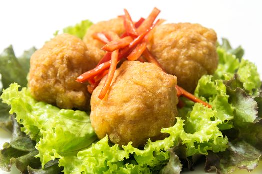 Deep fried shrimp balls, garnished with sliced red chili, red oak and green lettuce. Ingredients--shrimp meat, pork fat, pepper, salt, sugar. Deep fried with palm oil