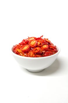 burning fat by eatin hot chili, sliced red chili in white ceramic bowl