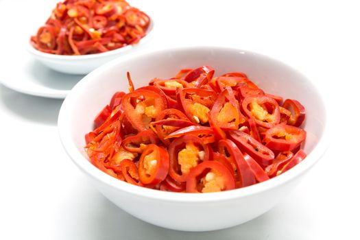 Burning fat by eating hot chili, Sliced red chili in white ceramic bowl