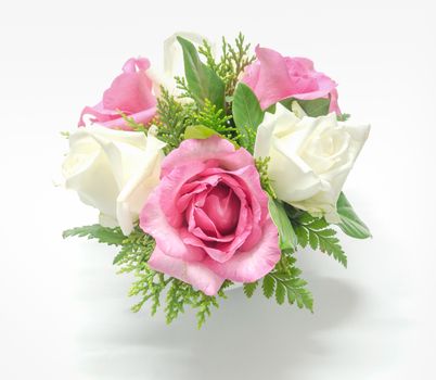 decorated pink and white roses with various leaves on white tone background