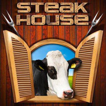 Wooden wall with an open window with a head of cow, text Steak house and two steel forks.