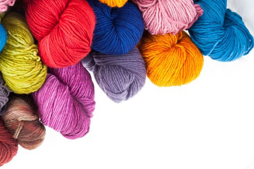 Set of colorful wool yarn balls. Hanks are set out in a pile.